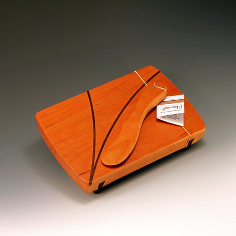 Small wood serving board with spreader by ThomasWork is an artisan handmade cherry wood serving and cutting board with decorative accents, handcrafted in the U.S.A..  Makes a great hostess or housewarming gift.