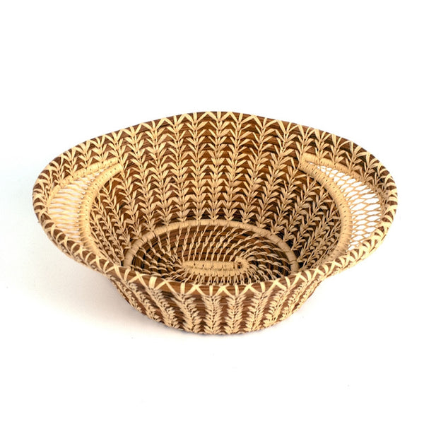 Lacy handle basket is a fair trade delicately handwoven basket made of pine needles and raffia created and designed by the women of Mayan Hands El Triunfo cooperative.