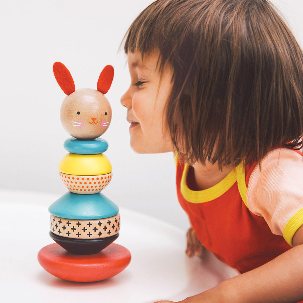Petit Collage wooden bunny stacking toy with child